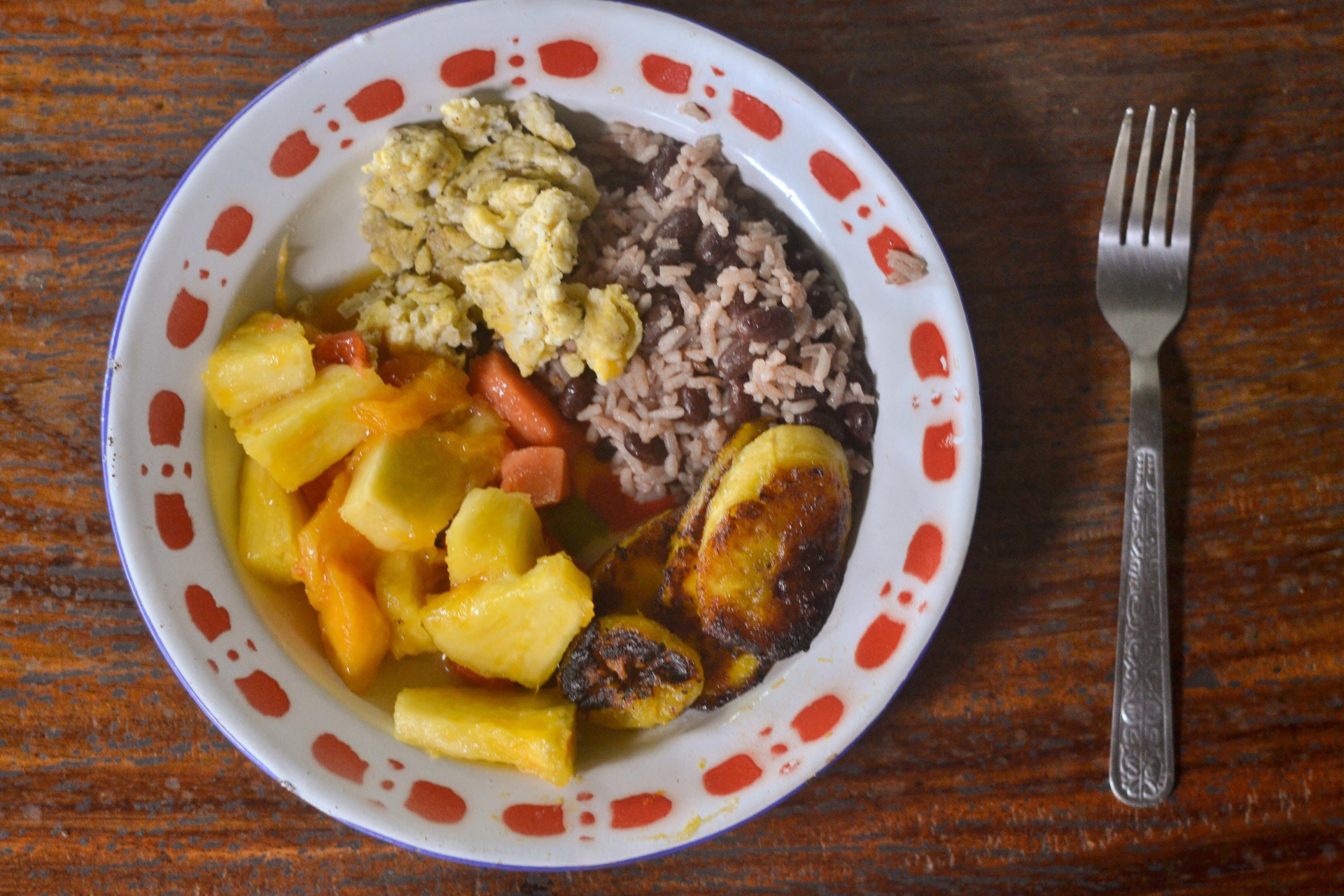  A typical breakfast: fresh mixed fruit, scrambled eggs, gallo pinto (rice and red beans mixed together), and fried plantains. 