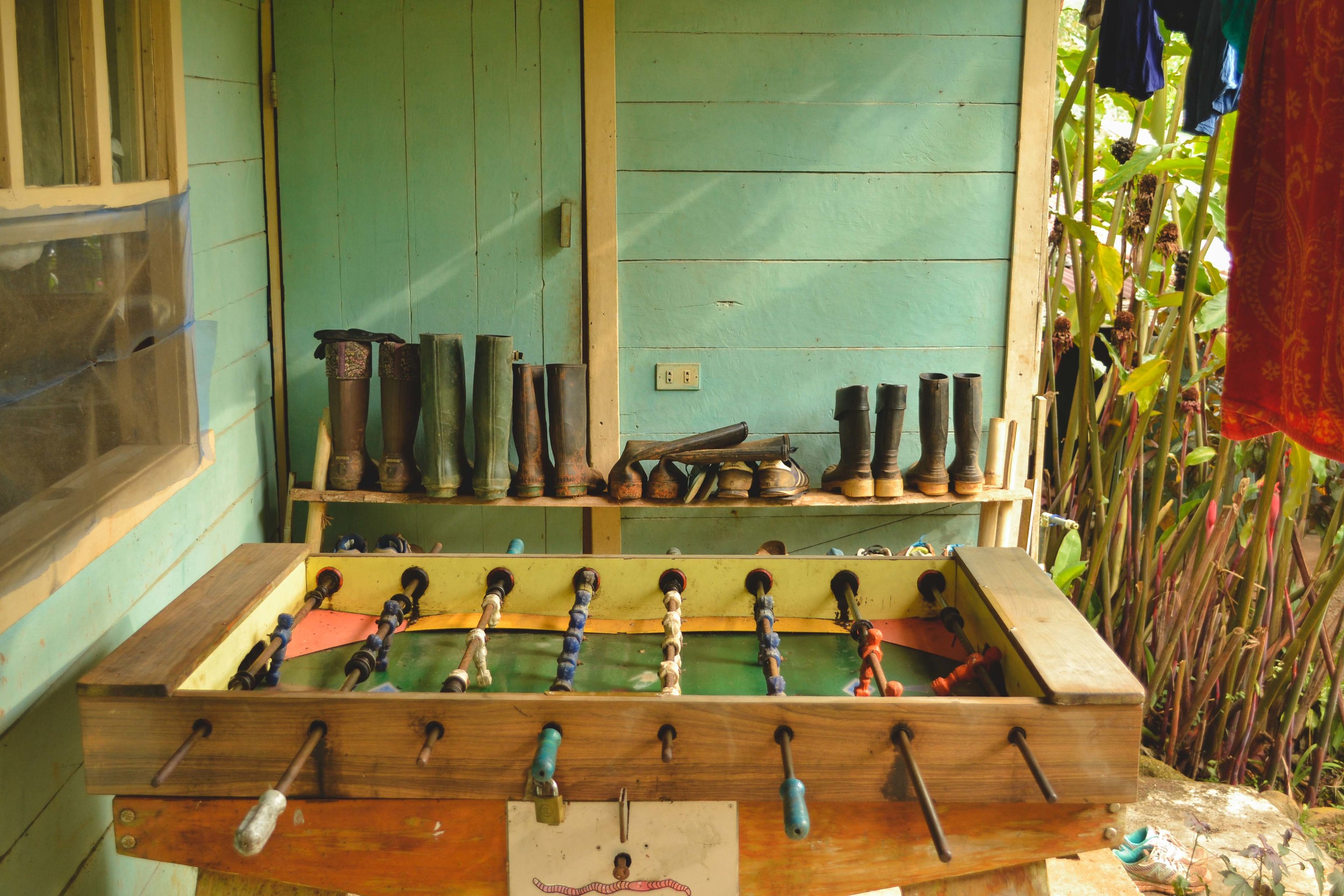  Volunteers' boots arranged near the volunteers' dorm and the foosball table 