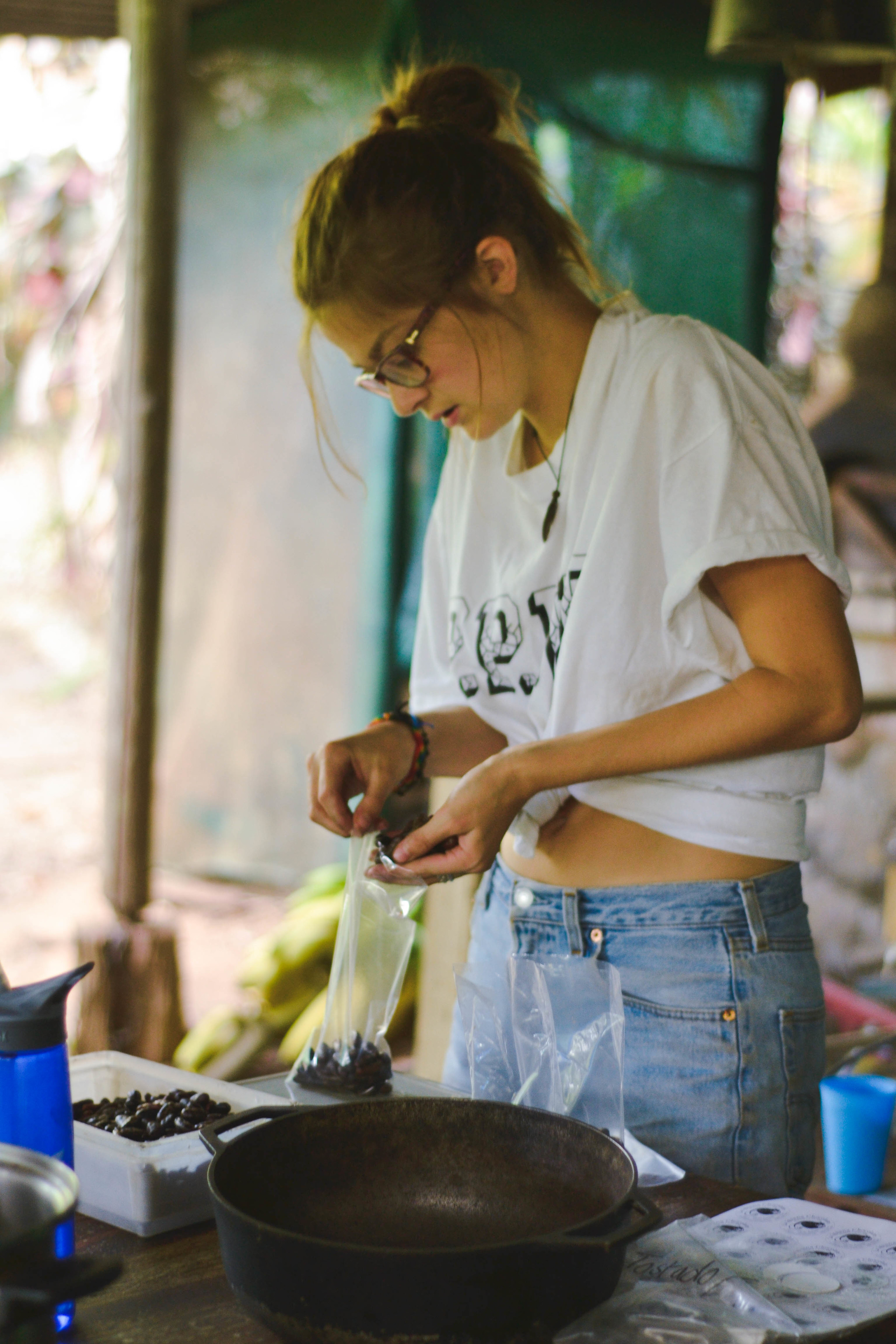  Amie puts toasted and peeled cacao beans into bags to sell 
