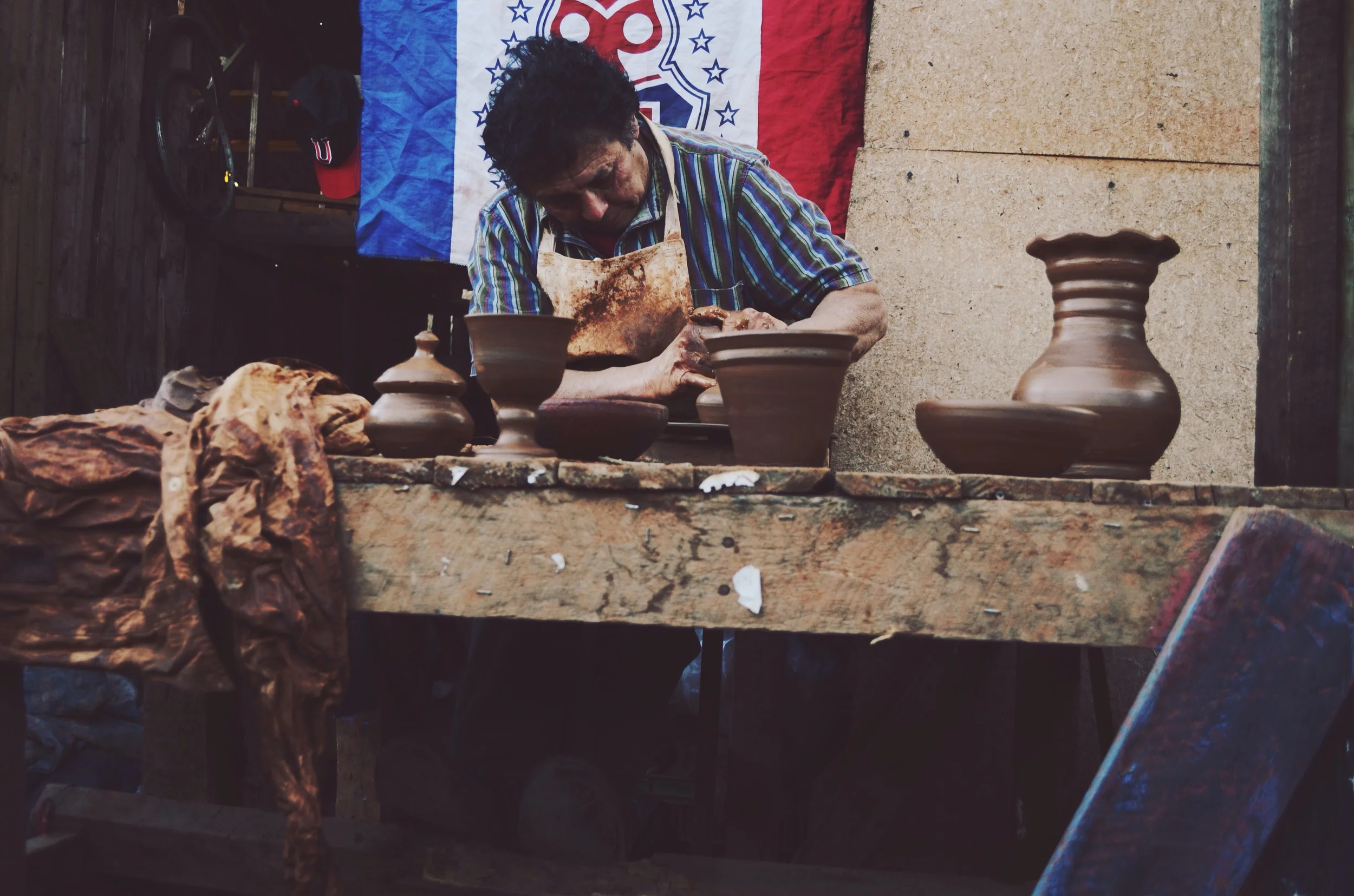 he learned from his father (who learned from his father) how to use the potter's wheel, and he can make up to 200 soup-size bowls in one day. all of the pottery sitting in front of him he made in the span of about 20 minutes. // 9 may 2015