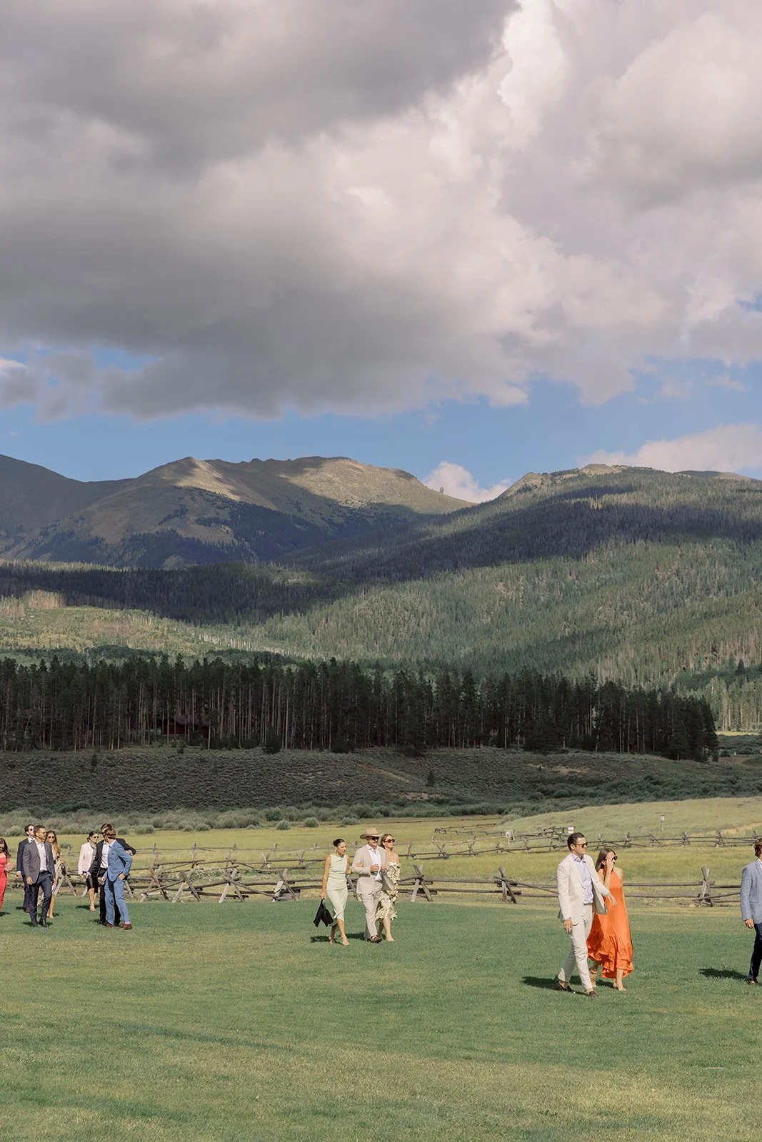 Guests walking to an outdoor wedding ceremony at Devil's Thumb Ranch in the mountains.
