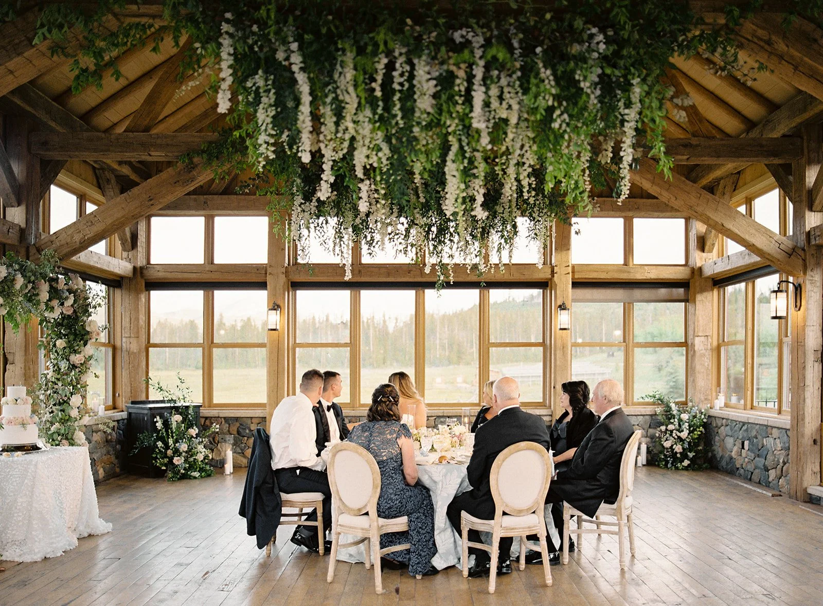 Wedding guests seated together for an intimate dinner inside Timber House.