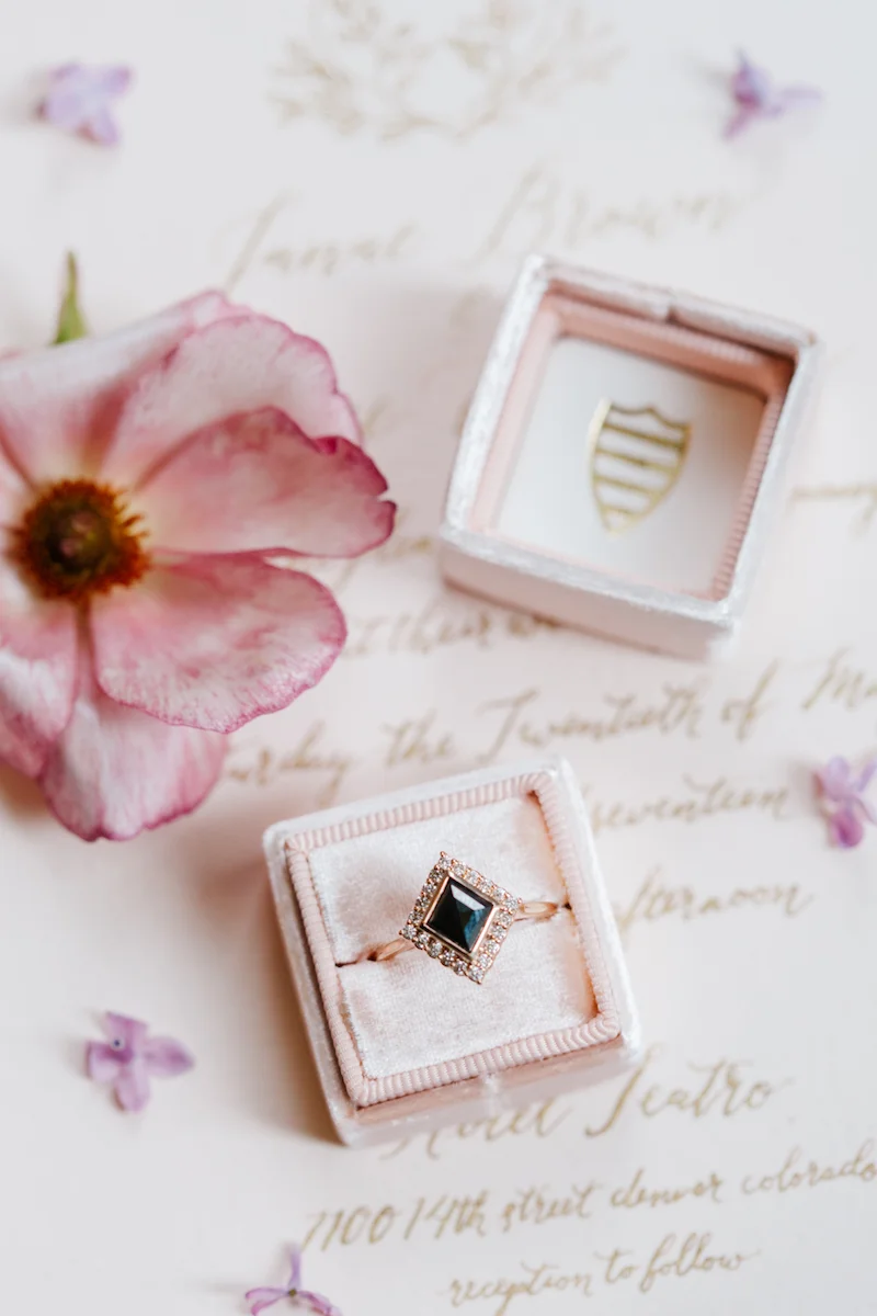 How to style wedding rings on invitations using flowers and a Mrs. Box by The Styled Soiree, photo by Emily Sacco