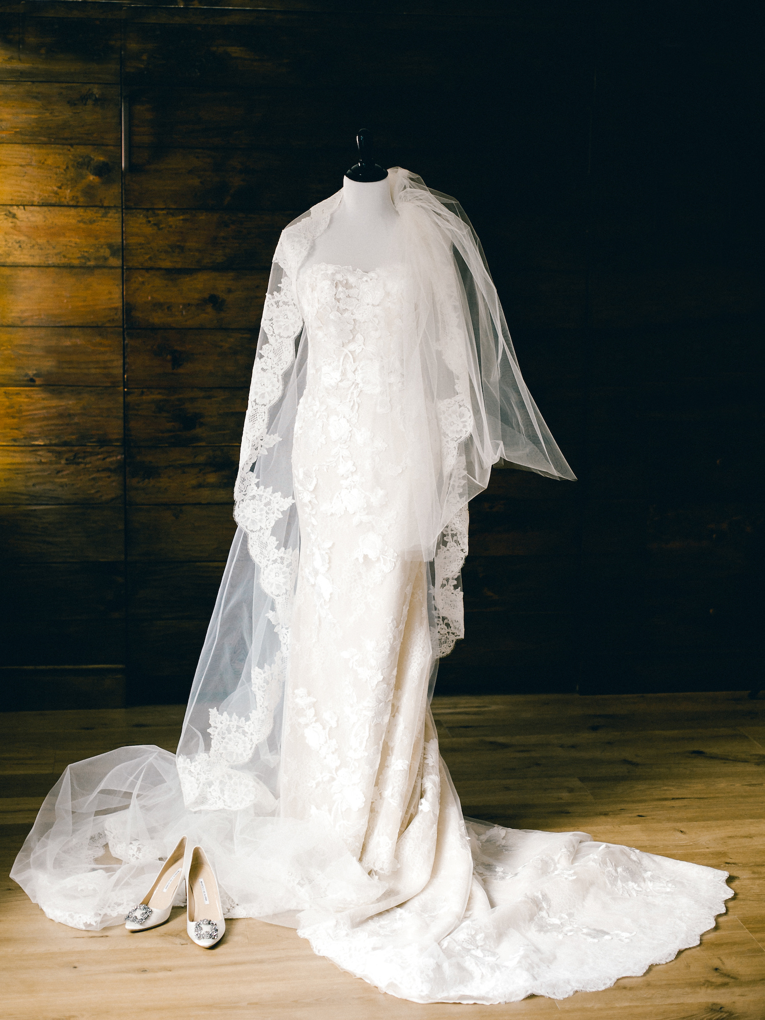 A wedding dress on a bust with a veil and shoes