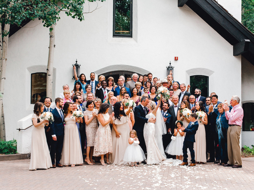 Group photo with all guests on the steps of Vail Interfaith Chapel after wedding ceremony