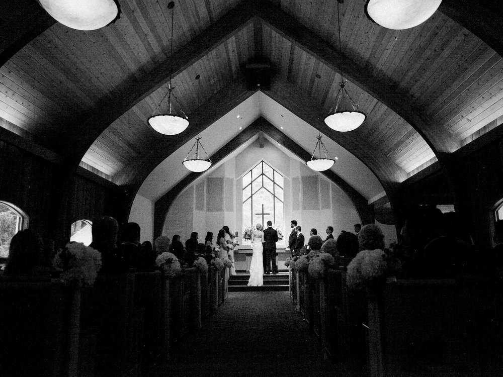 Wedding ceremony at Vail Interfaith Chapel in black and white