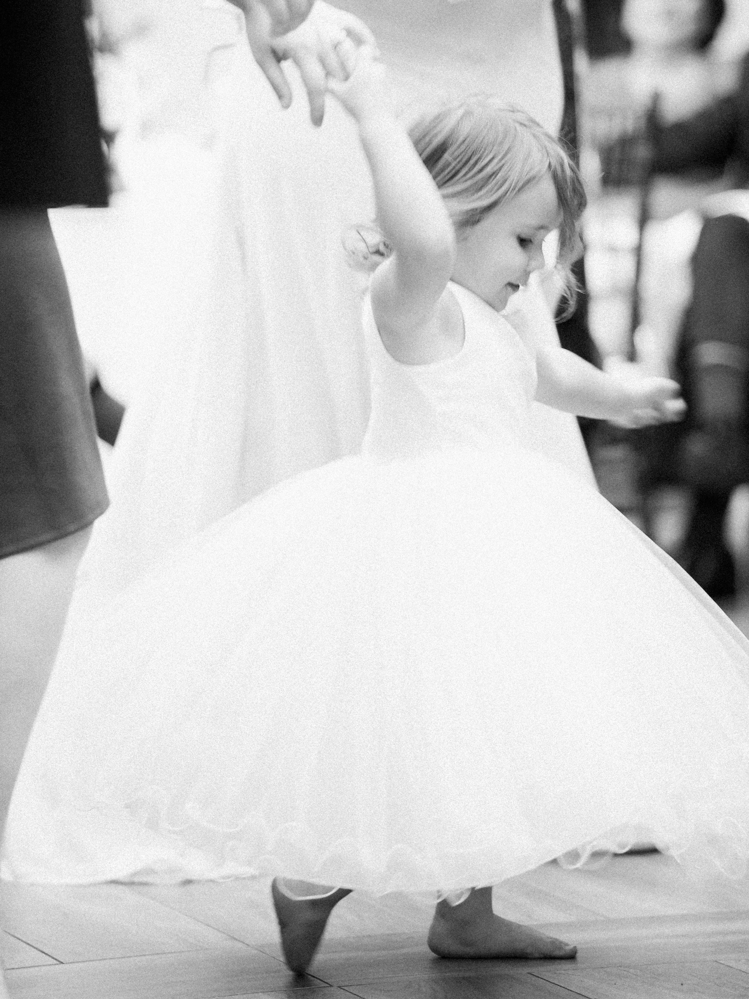 Flower girl twirling in a tutu at a wedding