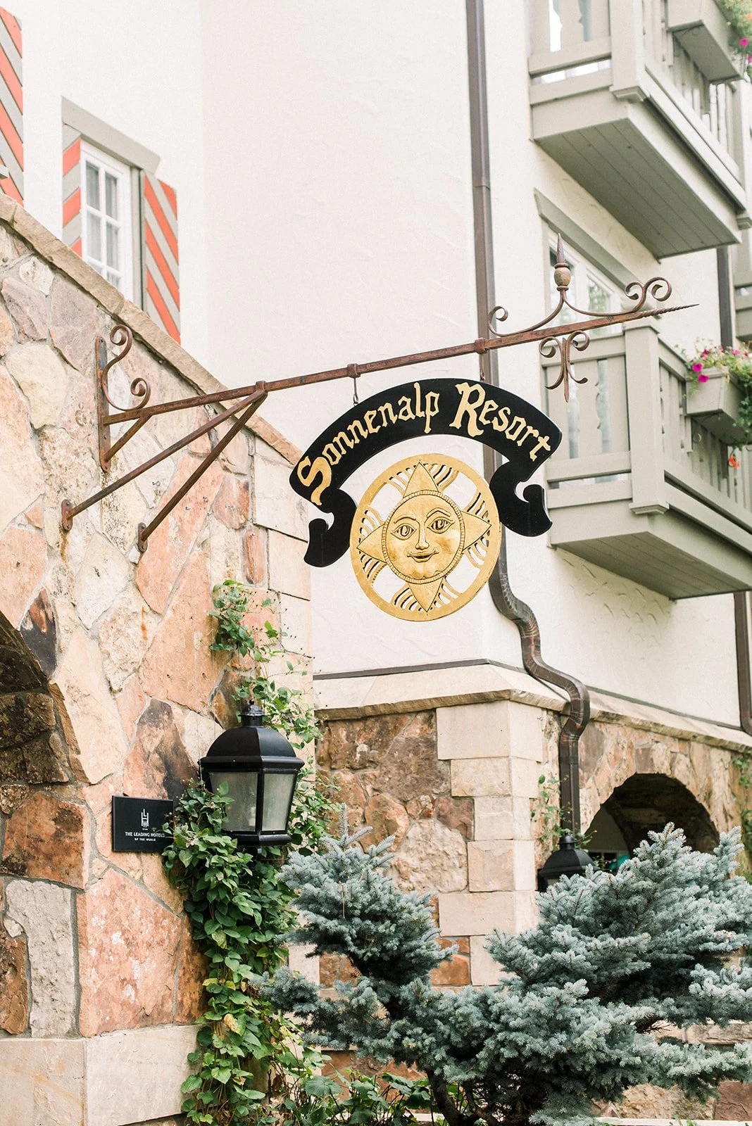 Exterior of The Sonnenalp in Vail with its carved resort sign and alpine-style stone façade.