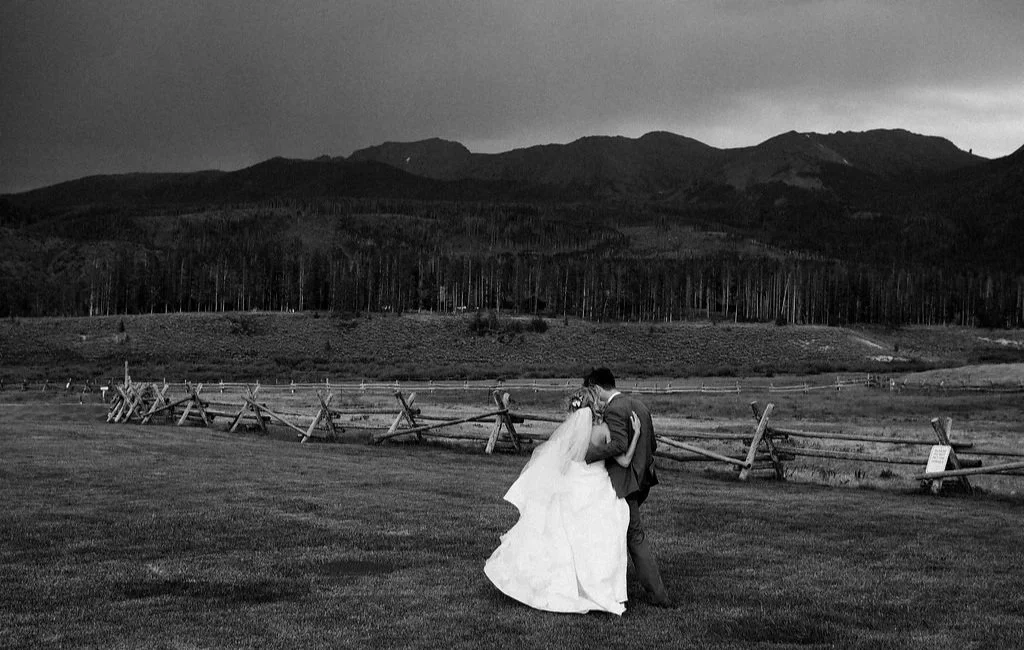 A couple taking photos at Devil's Thumb Ranch after their wedding