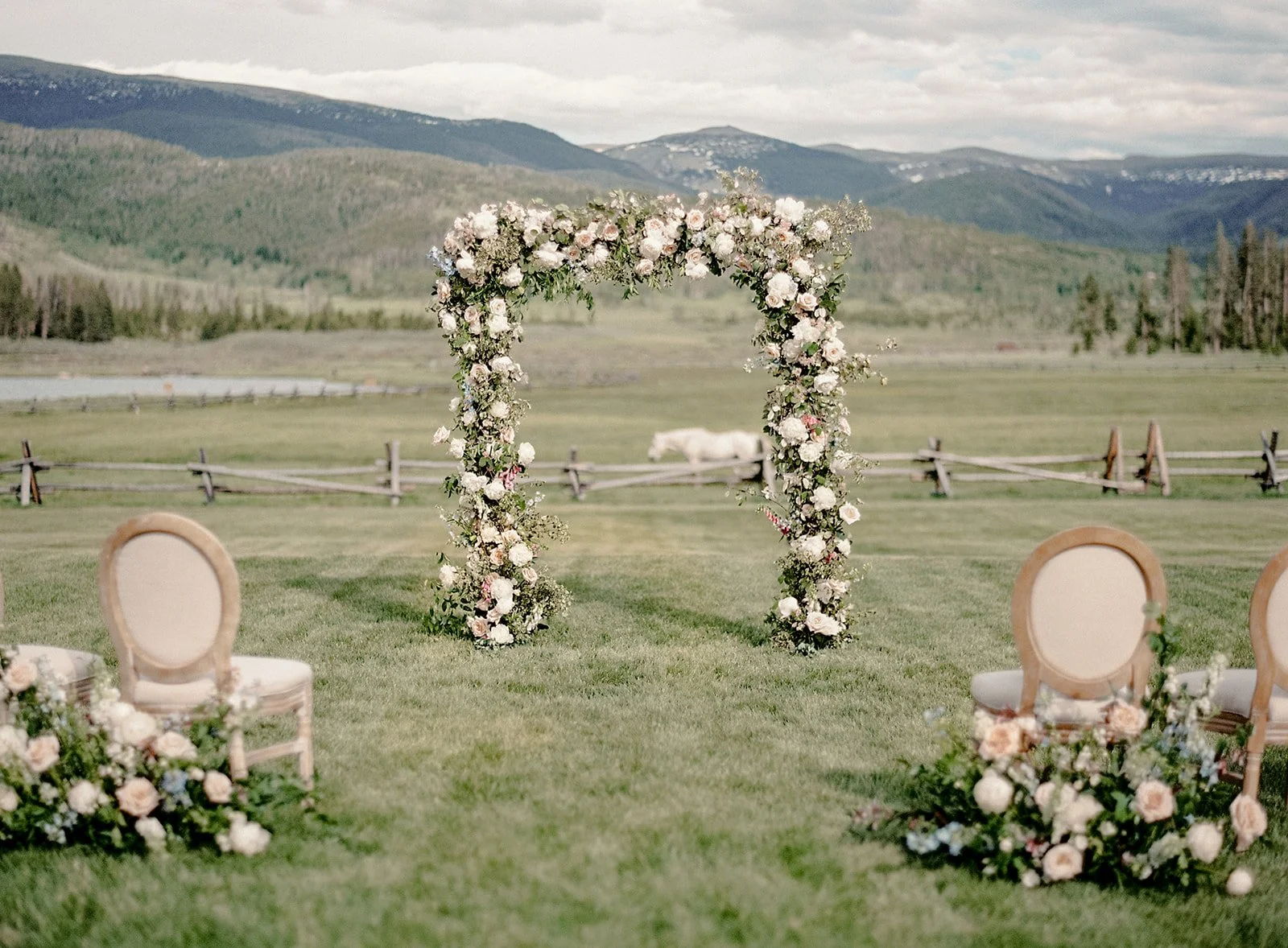 Floral wedding arch overlooking the mountains at Devil’s Thumb Ranch.