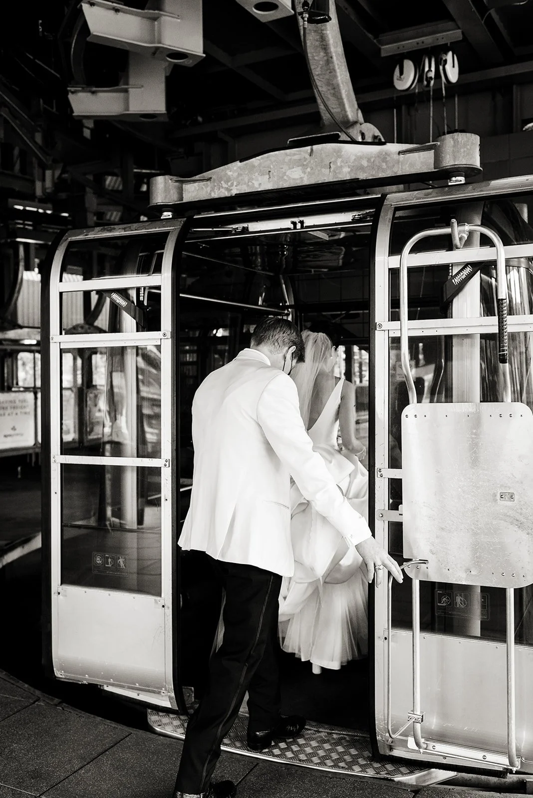 Bride and groom boarding a Vail gondola for their mountaintop wedding portraits.