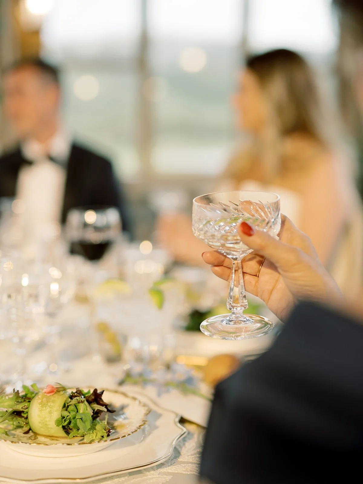 Wedding guest enjoying dinner and wine inside Timber House.