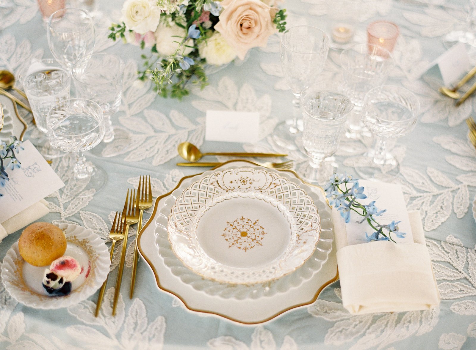 Antique porcelain and pale blue linens set for an intimate wedding dinner at Devil’s Thumb Ranch.