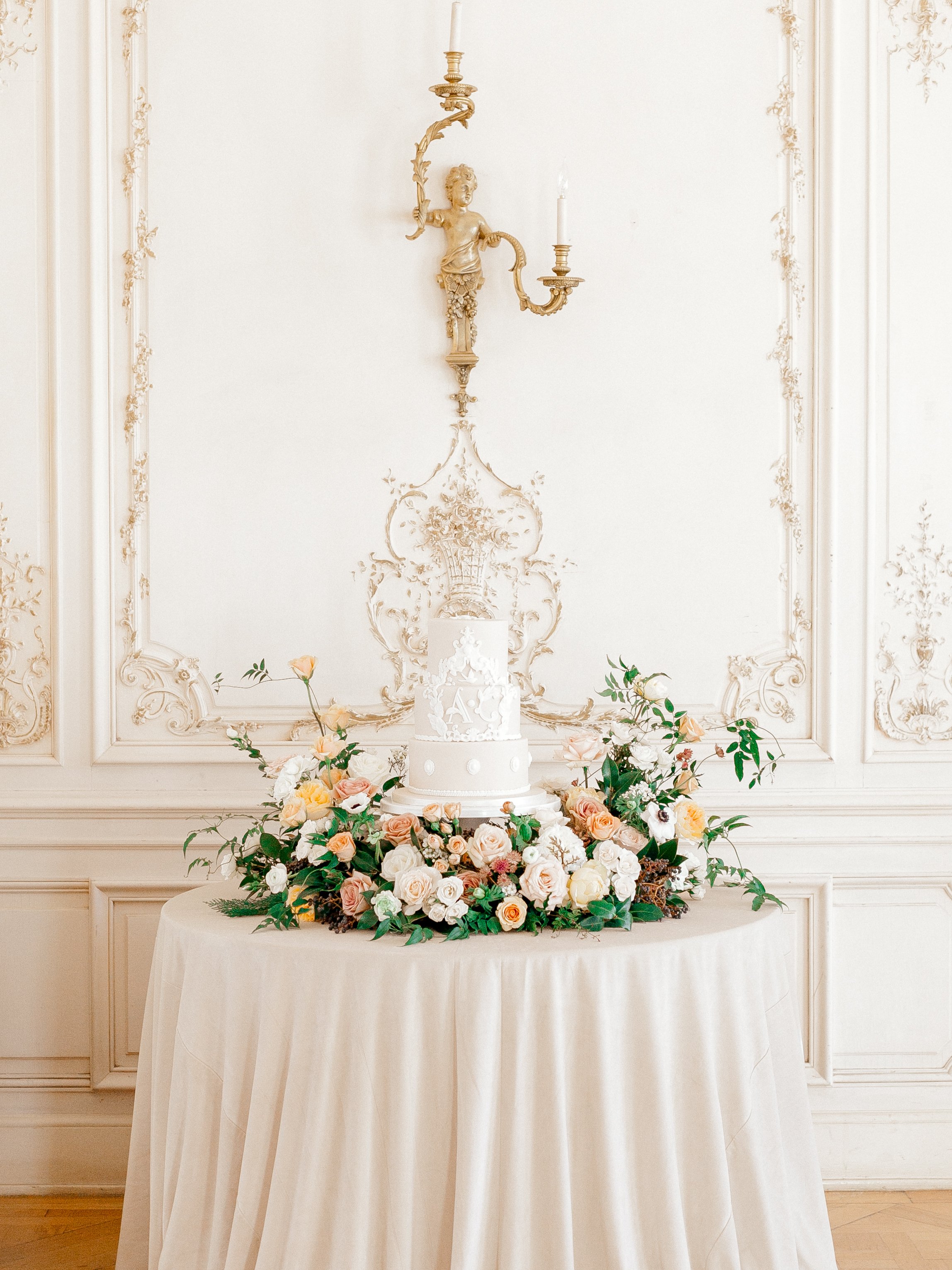 Editorial-style wedding reception design in Colorado featuring sculptural florals and an elegant wedding cake..