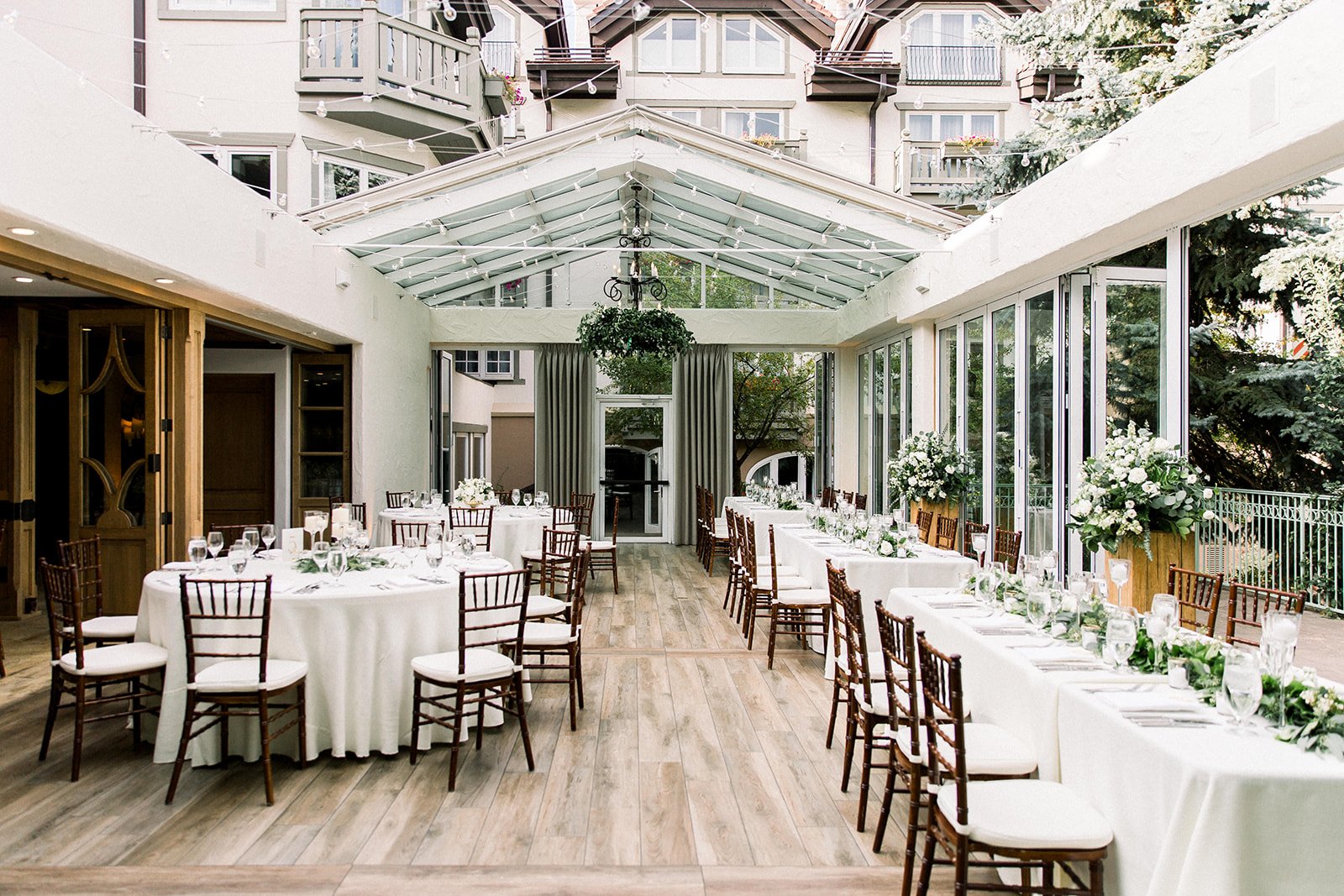 Wide view of the light-filled wedding reception inside The Sonnenalp.