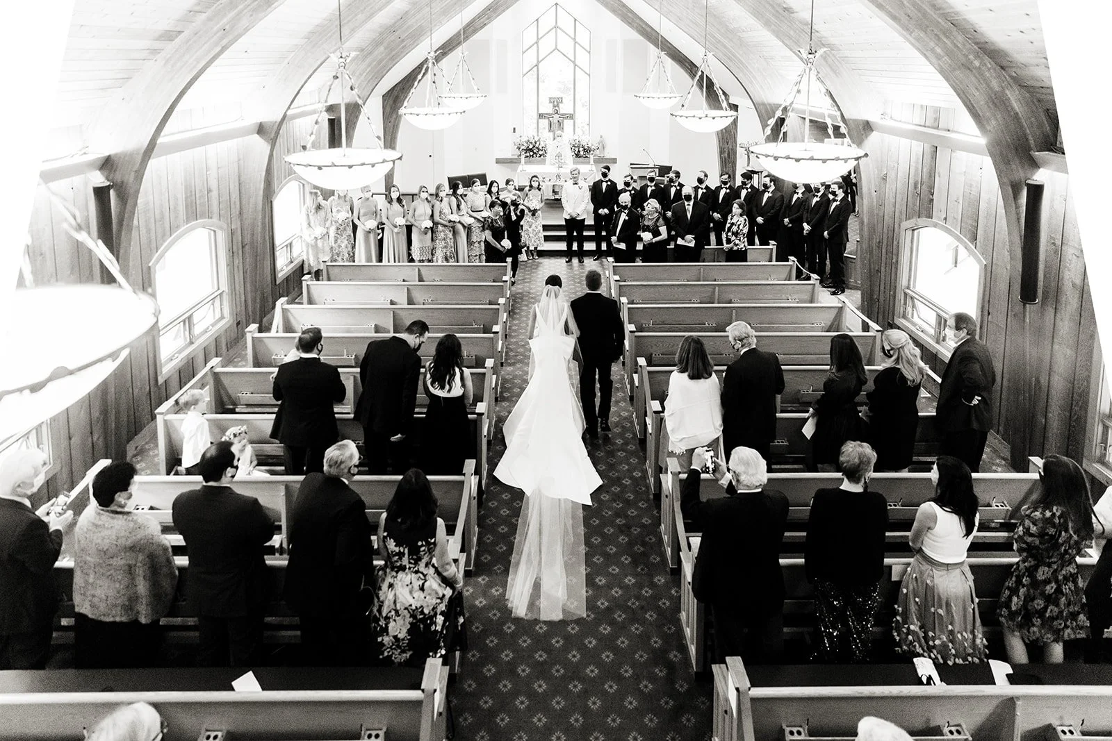 Bride walking down the aisle during a wedding ceremony at Vail Interfaith Chapel.