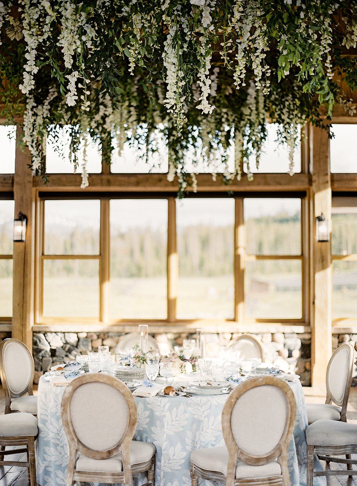 Hanging wisteria installation over a formal dinner at Devil's Thumb Ranch.
