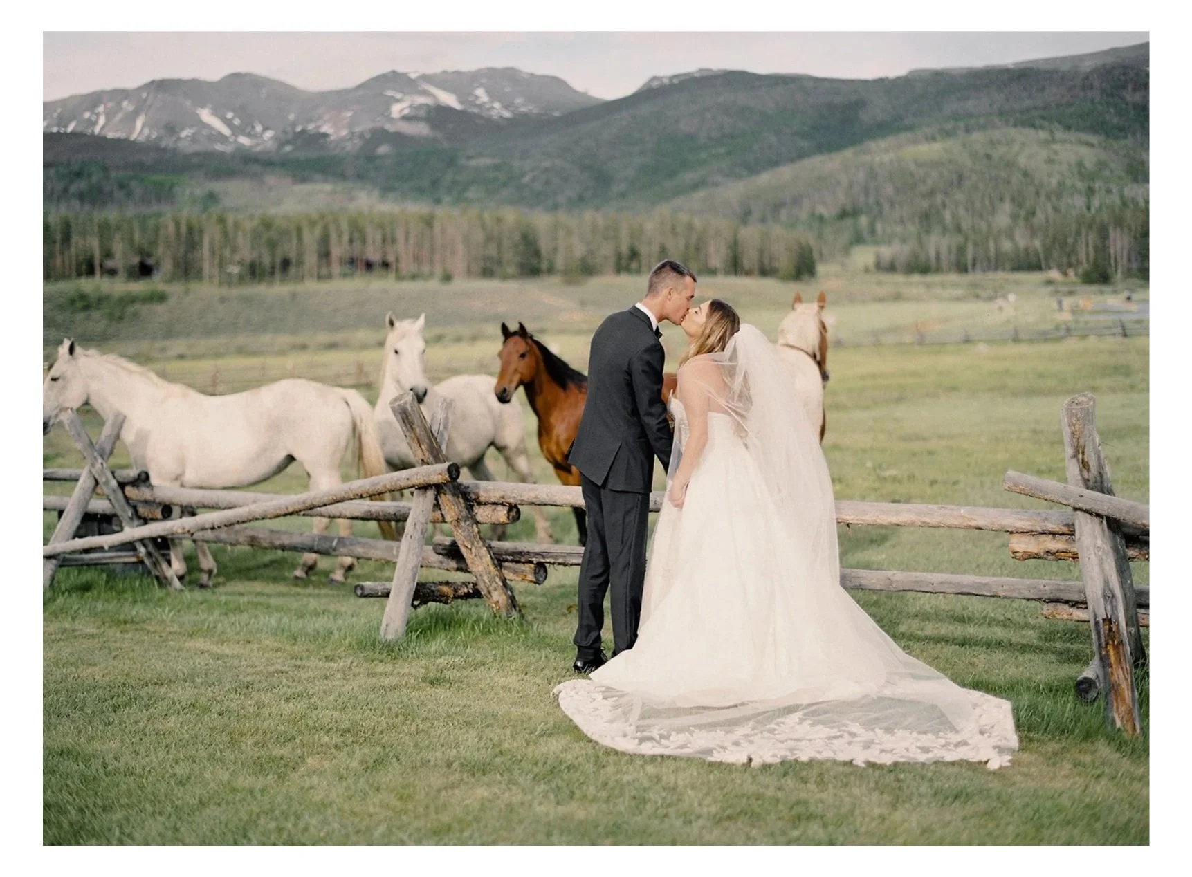 Wedding couple portraits at Devil’s Thumb Ranch with mountain backdrop and horses