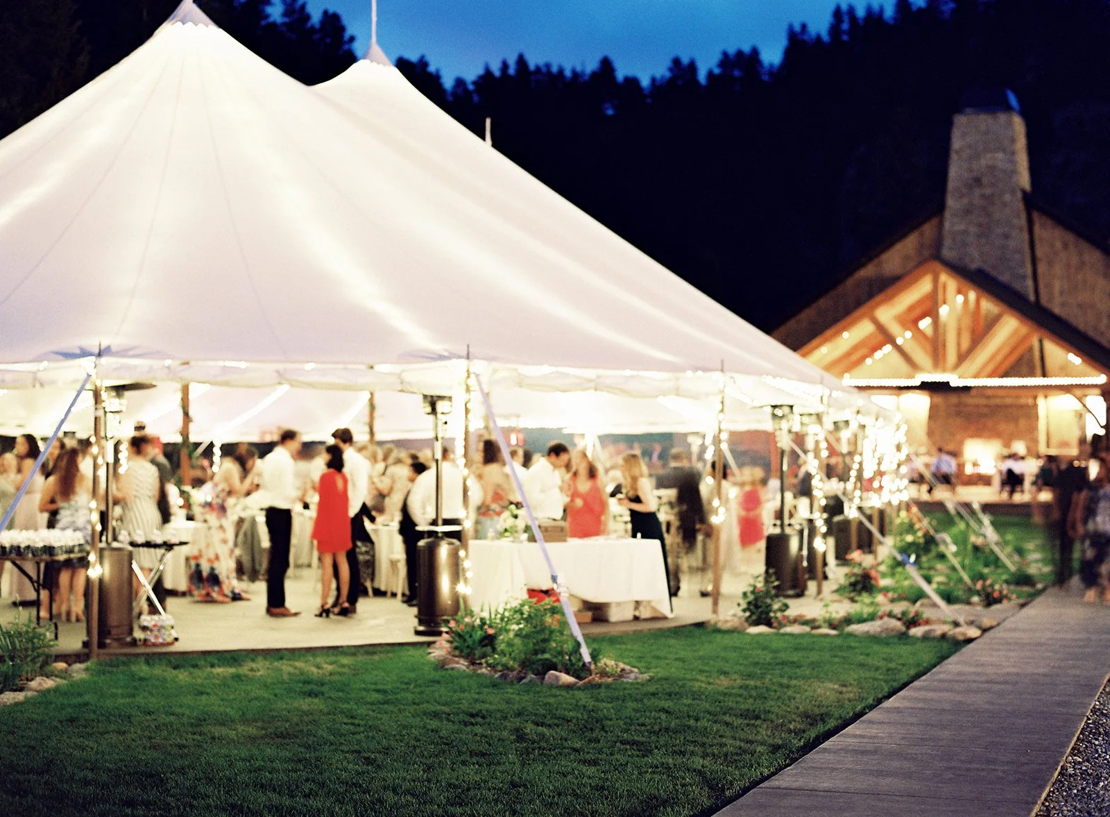 Tented wedding reception at Blackstone Rivers Ranch in Colorado with reception tent and nearby event spaces visible to guests