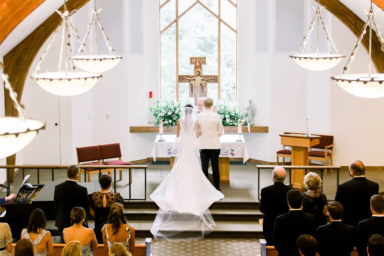 Bride and groom exchanging vows at the altar of Vail Interfaith Chapel.