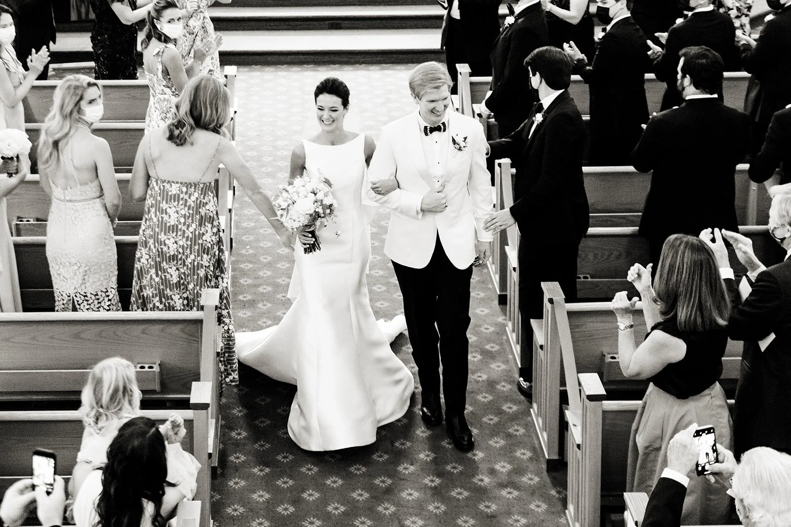 Newlyweds walking back up the aisle after their Vail Interfaith Chapel ceremony.
