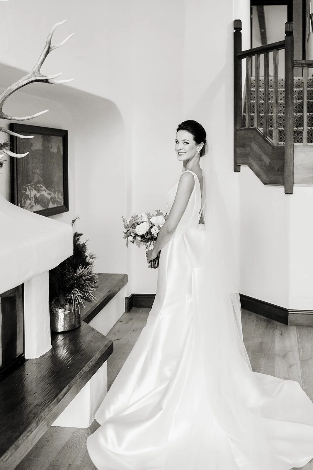 Black-and-white portrait of the bride in her sculptural gown inside The Sonnenalp.
