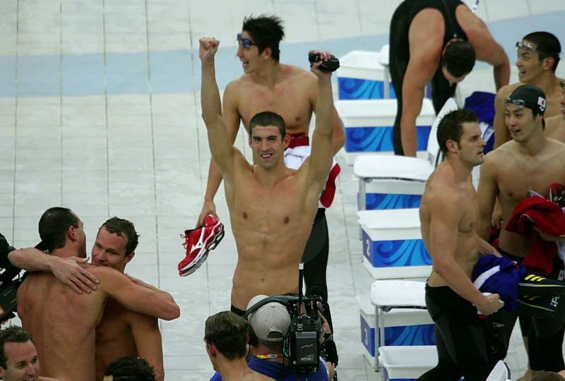 Michael Phelps celebrates his eighth gold medal of the Beijing Games with his teammates. Photograph by Bryan Allison.