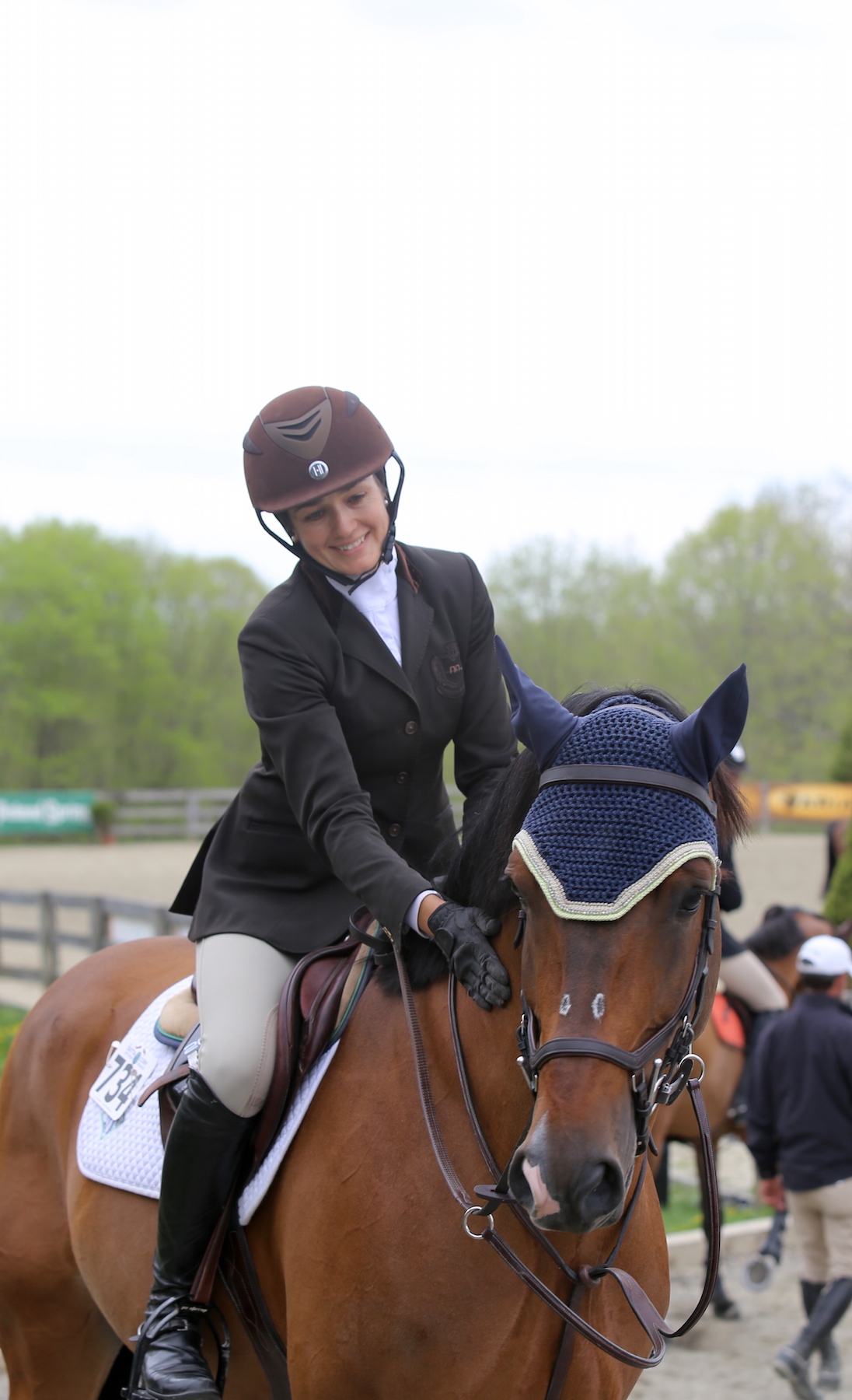   A hunter rider gives her mount a pat of encouragement before their round.&nbsp;Photo by Lindsay Brock for Jennifer Wood Media, Inc.  