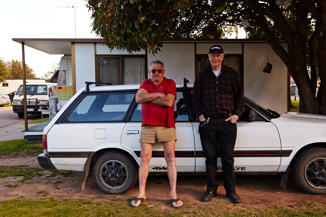 Ray Collinson and Lance Pilgrim stand in front of the former's caravan and annexe at Strayleaves, near Shepparton.