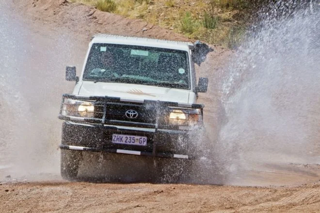 Toyota Land Cruiser from KEA Rentals, equipped with an African Outback Products camper shell with an integrated rooftop tent, an Engel freezer/fridge, and more.