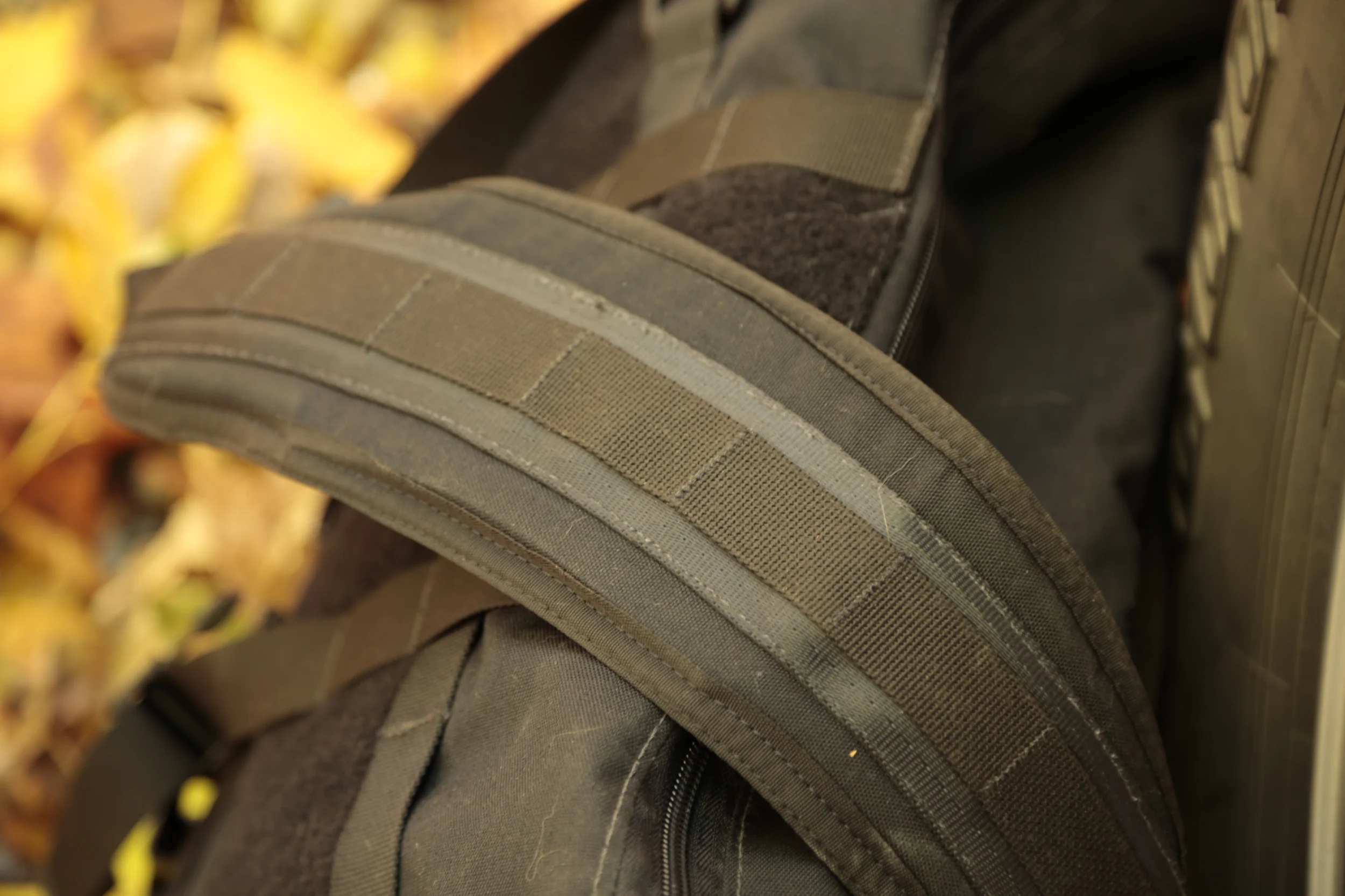 The shoulder strap with stitched loops for adding web dominators and ITW GrimLocs .