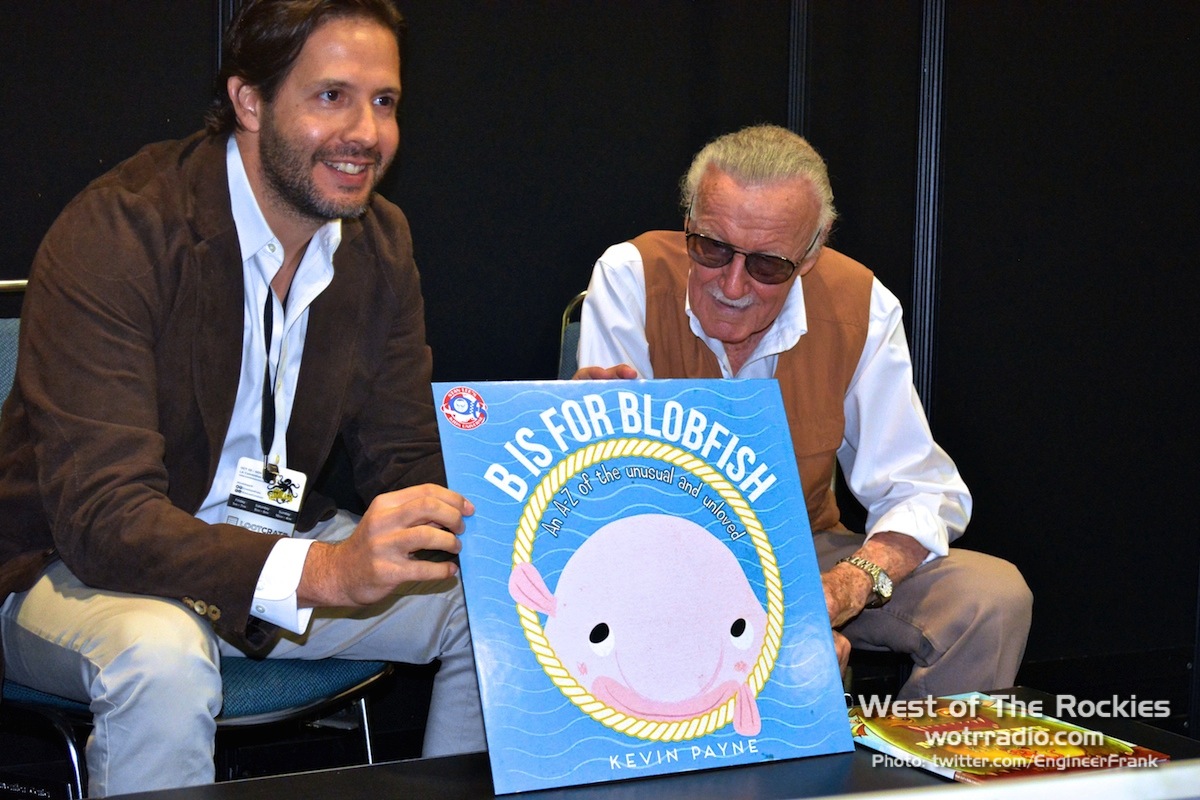 Terry Dougas proudly showing off the book that represents "the underdogs of the animal world."