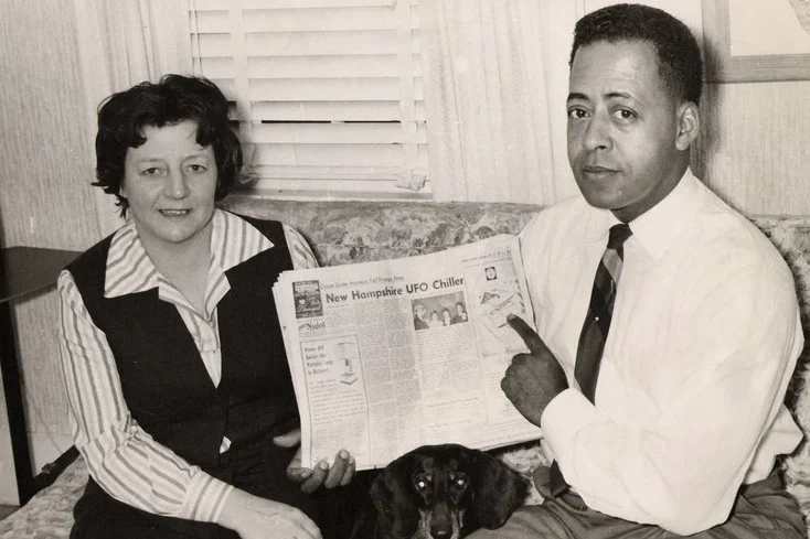 Betty and Barney Hill holding newspaper with the account of their abduction. (c. 1966)