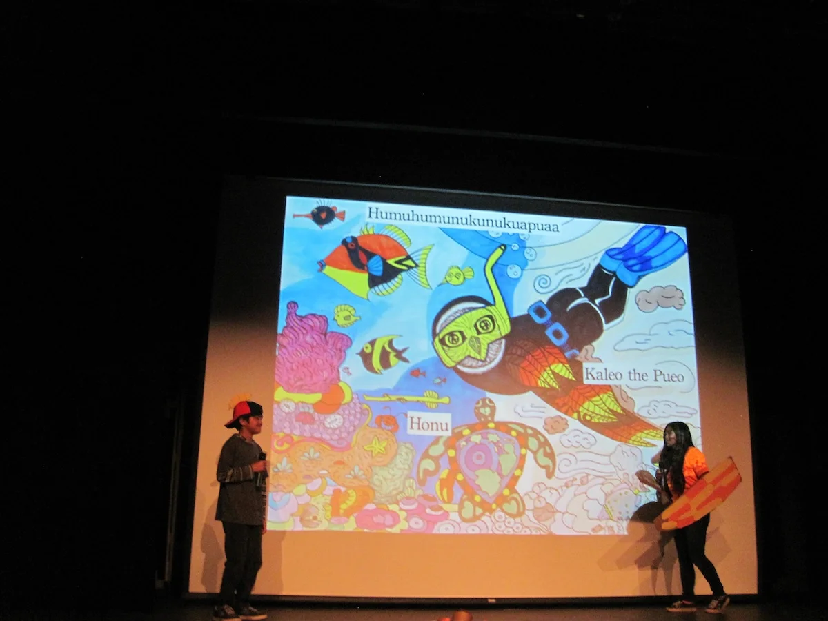 Kaleo the Pueo (right) finds out about Humuhumunukunukuapuaa's struggles with coral reef pollution due to wildfire runoff.