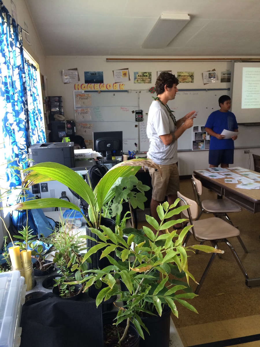 Tom Loomis reads off a plant card for the student judges - in the front of the picture are the plants we asked them to categorize as "good", "so-so", or "bad" Firewise plants.