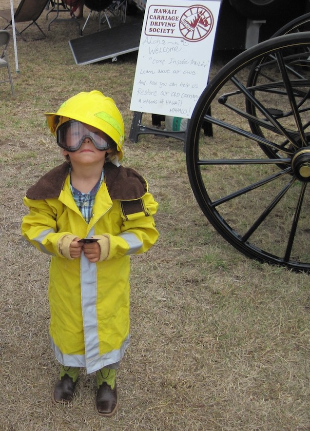 Young firefighter watches in awe as Polaroid come to life.