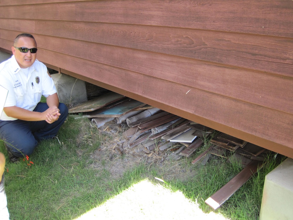 HFD Fire Inspector Palani Kurashige joined us and noted the hazardous scrapwood below a home.