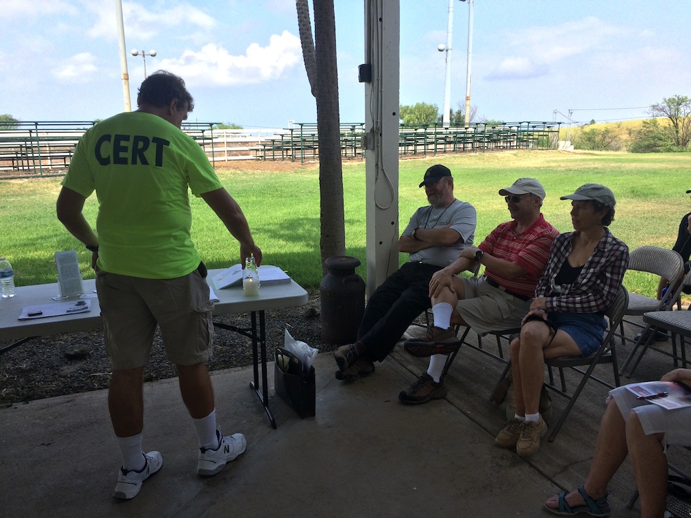 Waikoloa CERT's Mark Gordon puts a cup over a flame to demonstrate the fire triangle.