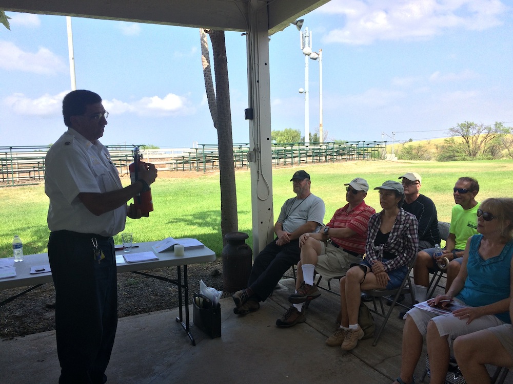 Battalion Chief Farias lends a hand in explaining different fire extinguisher types and safety precautions.