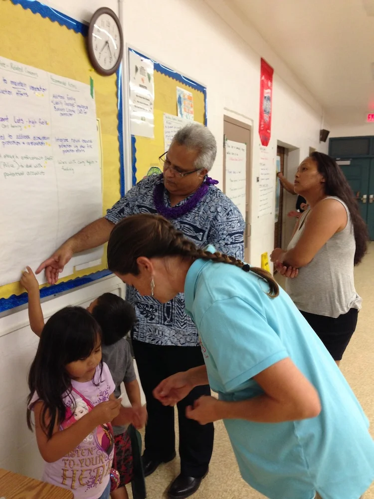 Councilman Kualii and keiki review input collected to decide which items to prioritize.