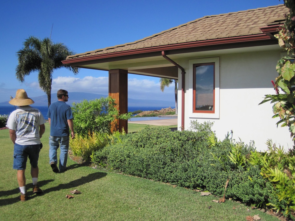Chris Brosius (right) examines native landscaping around home.