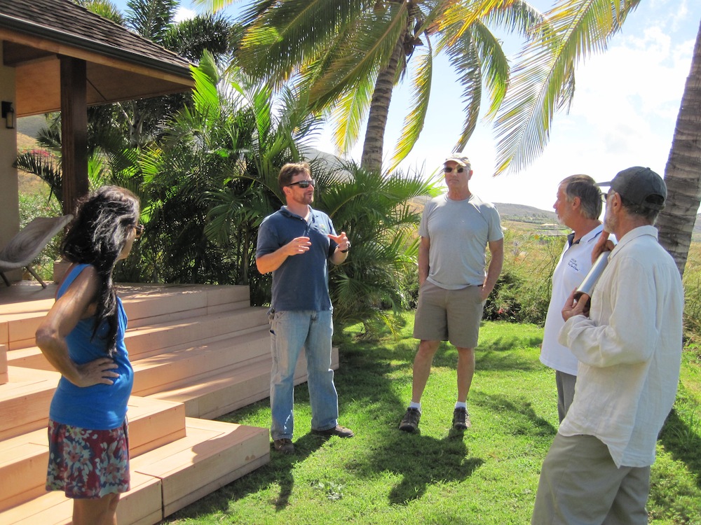 Chris Brosius (second from left) from West Maui Mountains Watershed Partnership explains the importance of defensible space to the Launiupoko Firewise Committee.