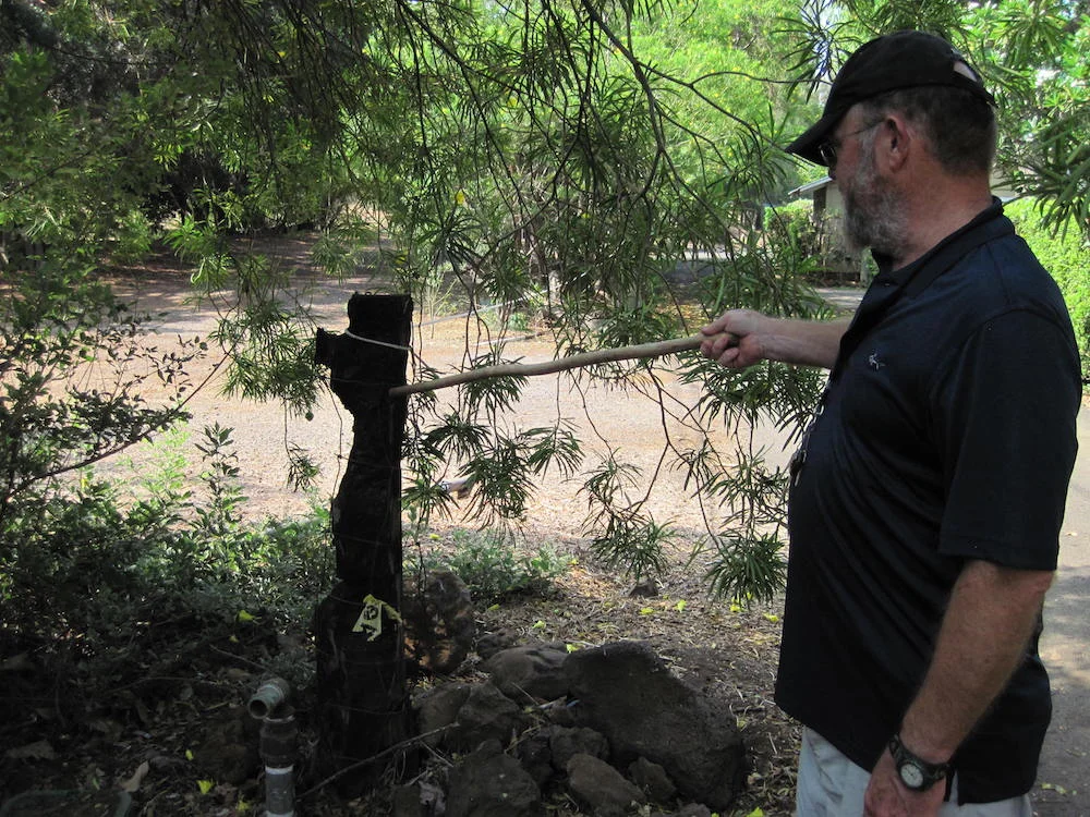 HWMO VP Sam Patten points out charred fire post from a previous wildfire that burned right up to homes in Waialea.