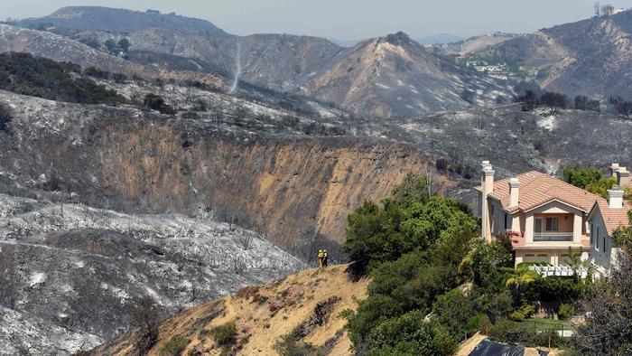 "Burned hillsides surround a home in Calabasas." (Michael Owen Baker/AFP/Getty Images)