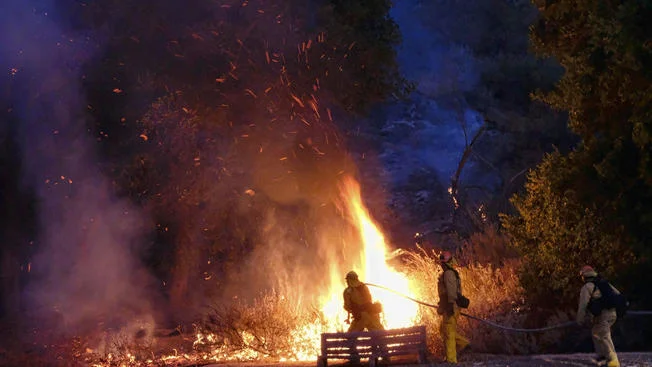 "Embers burn as firefighters approach a brush fire in the foothills outside of Calabasas, Calif. on Saturday, June 4, 2016. A fast-moving brush fire sweeping through hills northwest of downtown Los Angeles has damaged homes and prompted neighborhood evacuations. Los Angeles County fire officials now say the brushfire is threatening about 3,000 homes in the Calabasas neighborhood." Credit: AP