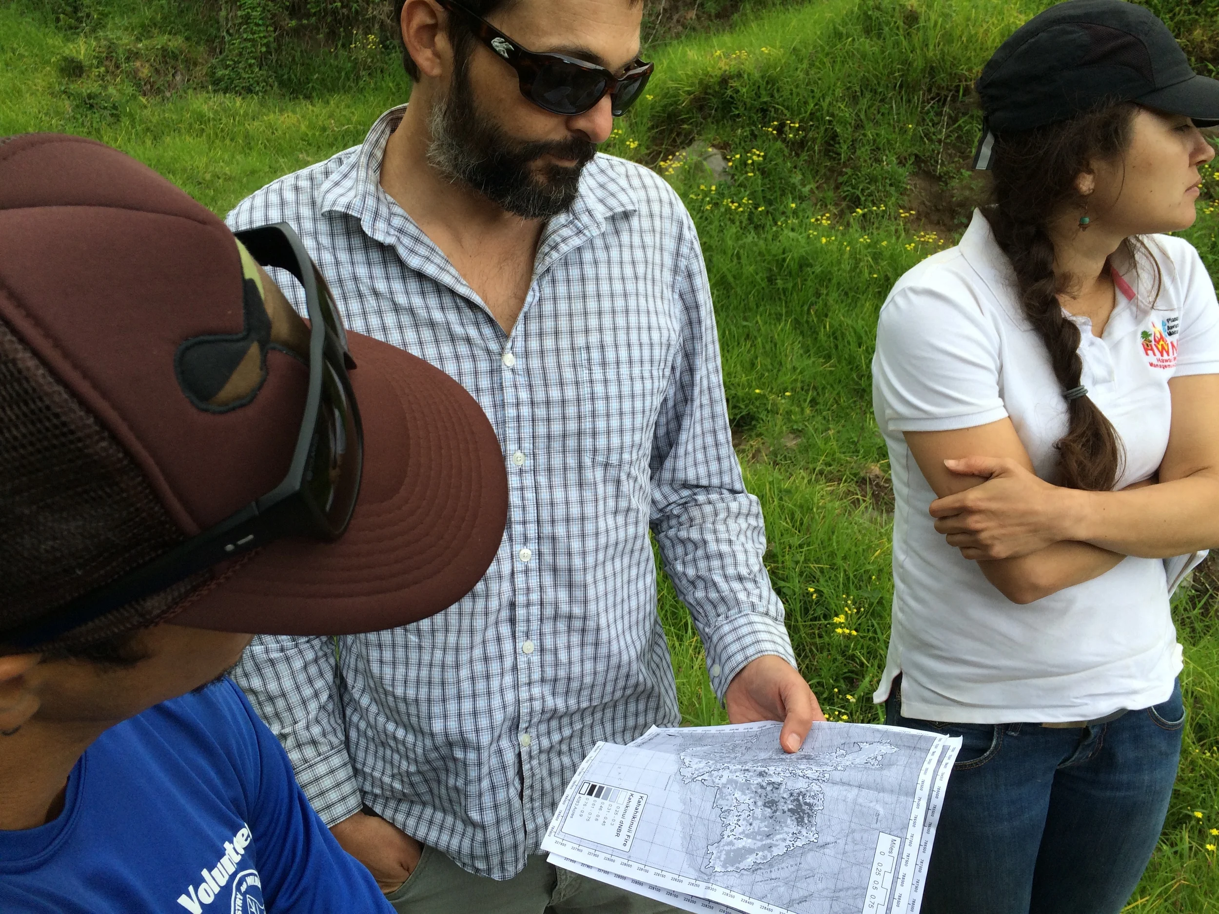 Clay Trauernicht of UH CTAHR Cooperative Extension/PFX (middle) ground-truths wildfire intensity maps.