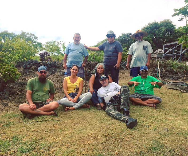 Assessment team poses in front of a local example of xeriscaping using Firewise principles and native/adapted plants.