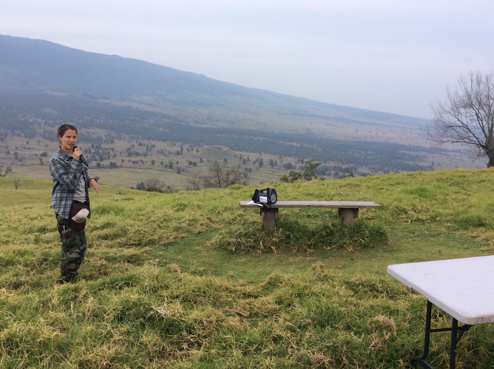 Leila Dudley, DOFAW, with Hualalai in the background, shares moʻolelo about Puʻu Waʻawaʻa and its surrounding areas.