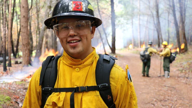 "Rony Reed, a Karuk tribal member, participates in a burn at Bacon Flat in Orleans, California. Photo by Stormy Staats / Klamath Salmon Media Collaborativemaker."