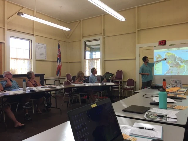 Pablo Beimler pointing to a map of wildfire hazards in Northwest Hawaiʻi Island during the CDP presentation. Credit - David Tarnas